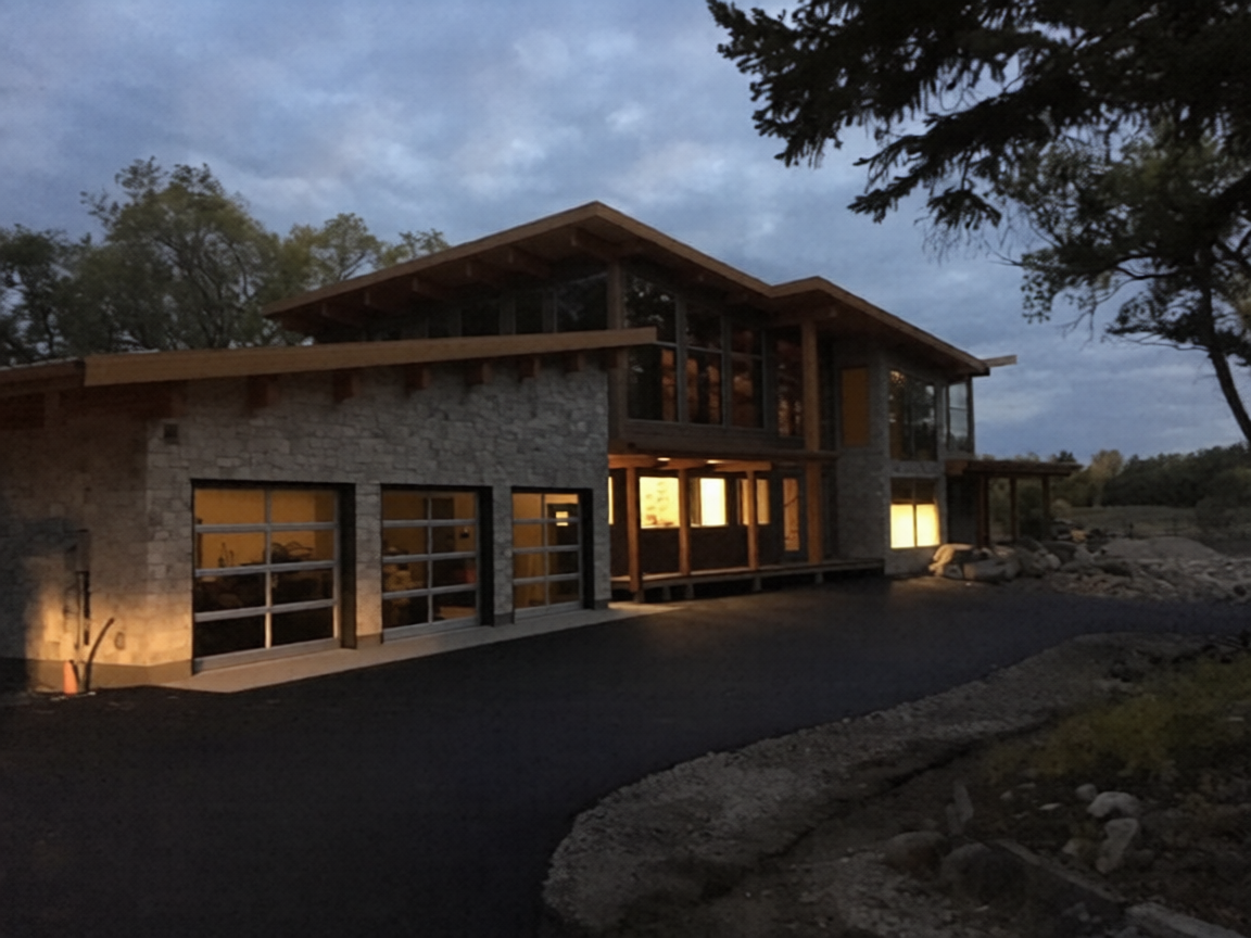 A finished asphalt approach on a rural Saskatchewan property at dusk