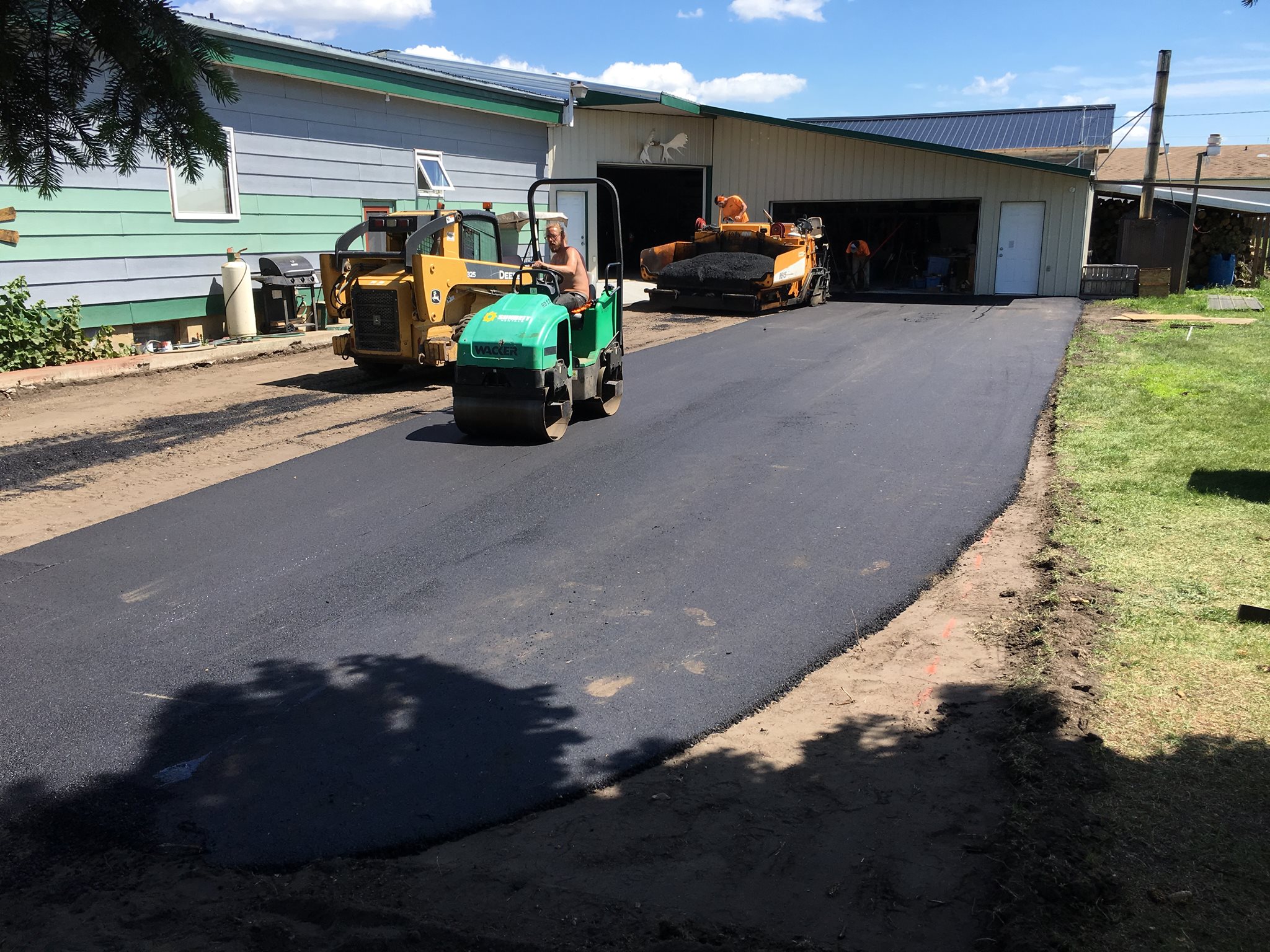 Covenant Construction crew laying fresh asphalt